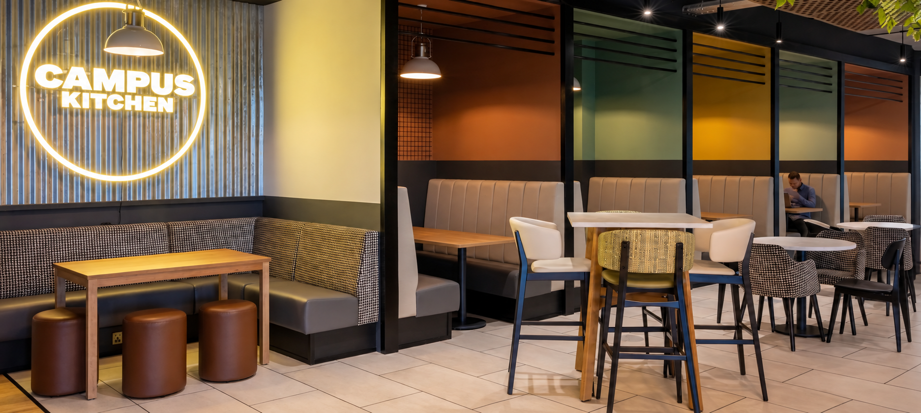 Commercial cafe with fitted booth seating and coordinated tables and chairs